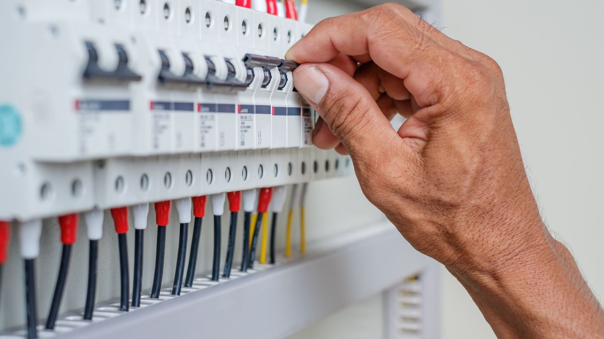 Hand adjusting circuit breakers in an electrical distribution panel