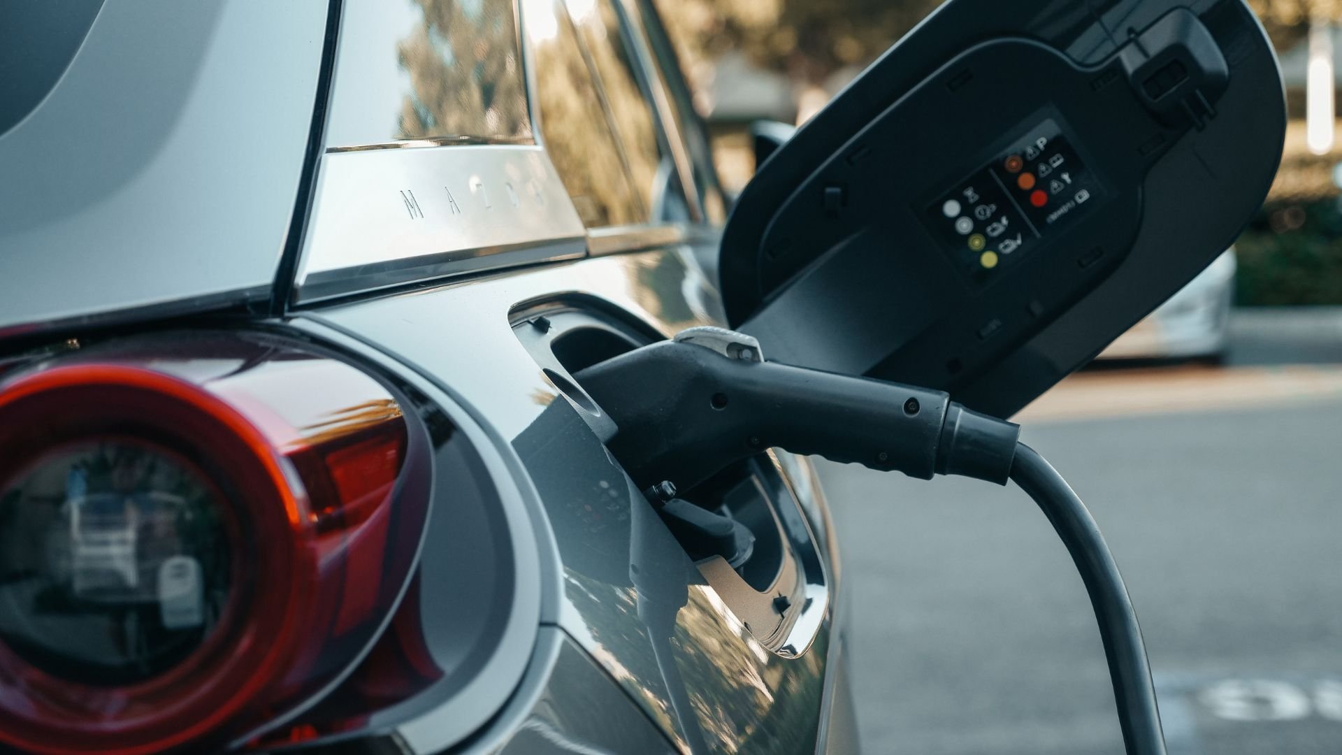 Electric vehicle charging, close-up of plug connected to car socket